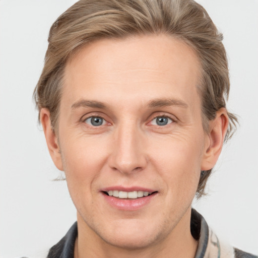 Joyful white adult male with medium  brown hair and grey eyes