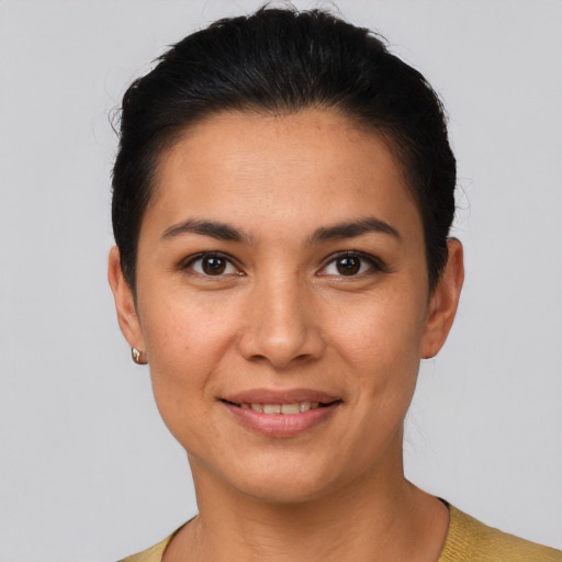 Joyful latino young-adult female with short  brown hair and brown eyes