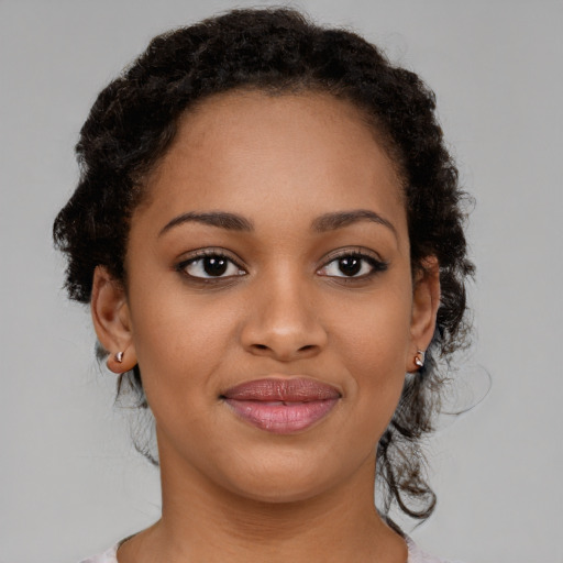 Joyful black young-adult female with medium  brown hair and brown eyes