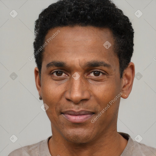 Joyful black young-adult male with short  black hair and brown eyes