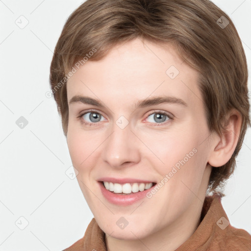 Joyful white young-adult female with short  brown hair and grey eyes