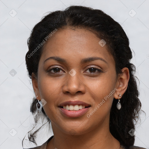 Joyful black young-adult female with long  brown hair and brown eyes