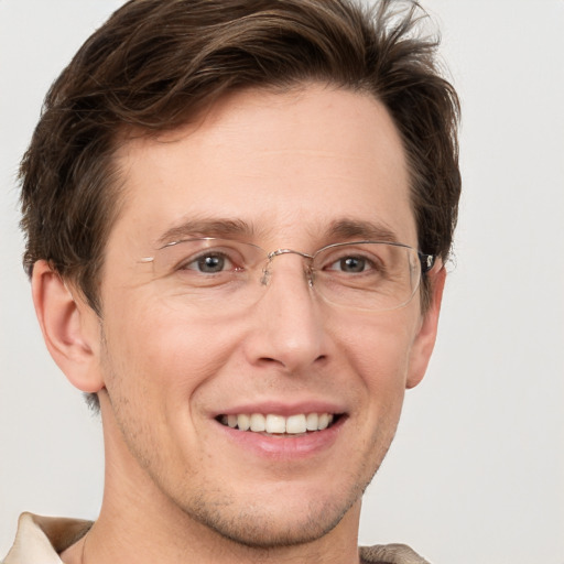 Joyful white adult male with short  brown hair and grey eyes