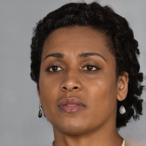 Neutral black young-adult female with short  brown hair and brown eyes