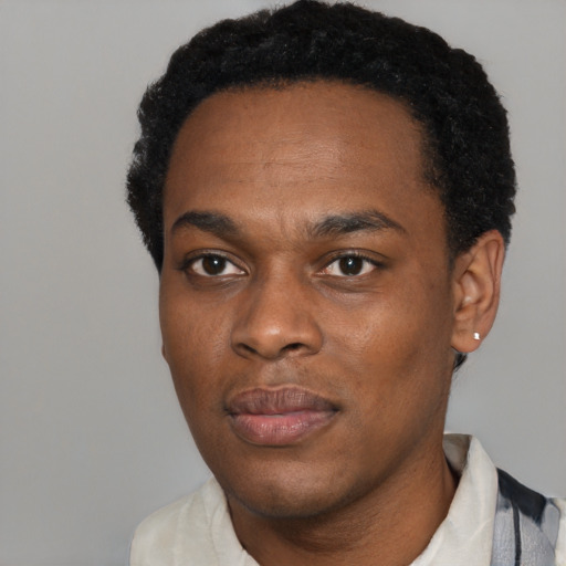 Joyful black young-adult male with short  black hair and brown eyes