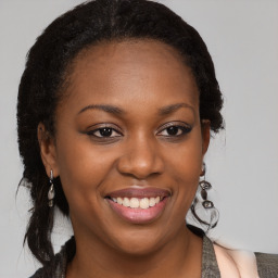 Joyful black young-adult female with medium  brown hair and brown eyes