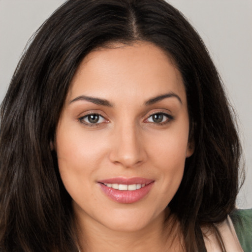 Joyful white young-adult female with long  brown hair and brown eyes