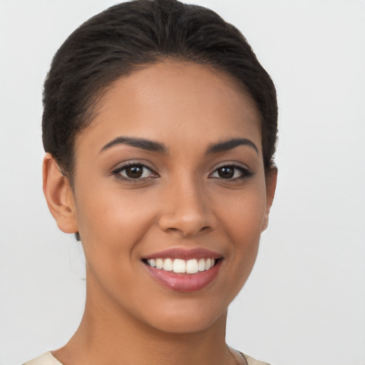 Joyful latino young-adult female with short  brown hair and brown eyes