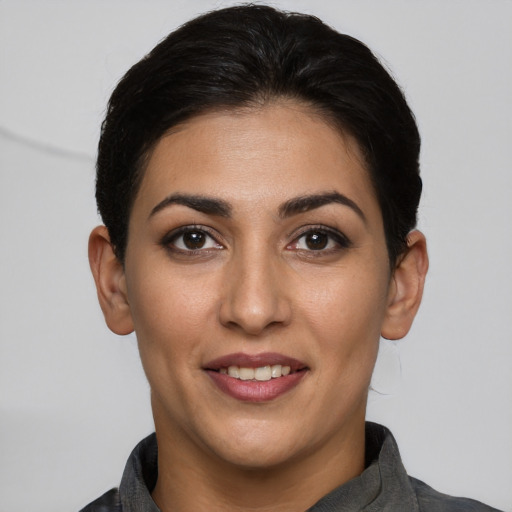 Joyful white young-adult female with short  brown hair and brown eyes