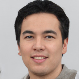 Joyful asian young-adult male with short  black hair and brown eyes