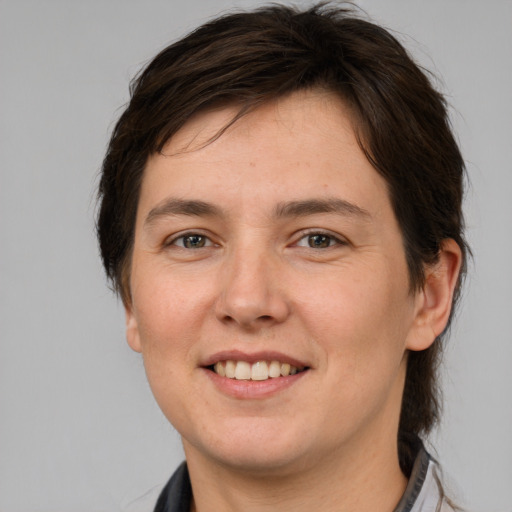 Joyful white young-adult female with medium  brown hair and brown eyes