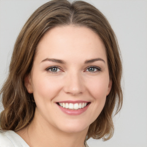 Joyful white young-adult female with medium  brown hair and green eyes