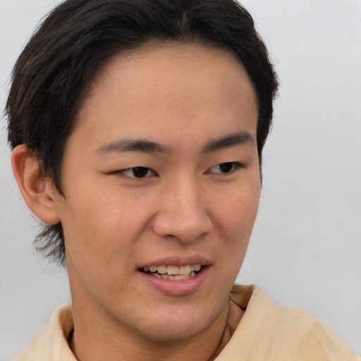 Joyful asian young-adult male with short  brown hair and brown eyes
