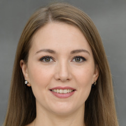 Joyful white young-adult female with long  brown hair and grey eyes