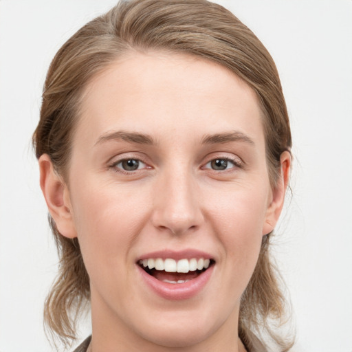 Joyful white young-adult female with medium  brown hair and blue eyes