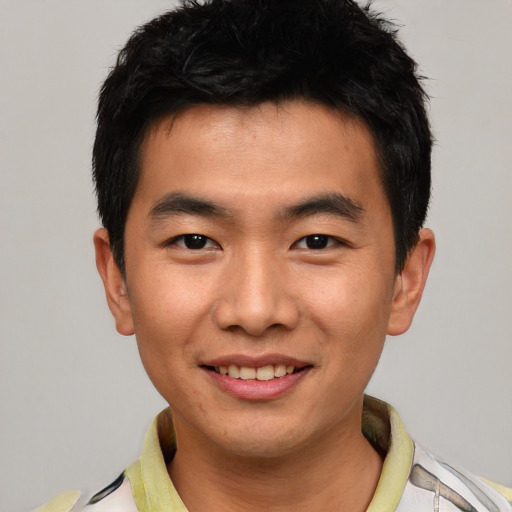 Joyful asian young-adult male with short  black hair and brown eyes