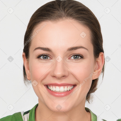 Joyful white young-adult female with medium  brown hair and green eyes