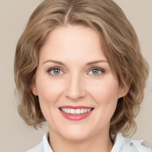 Joyful white young-adult female with medium  brown hair and green eyes