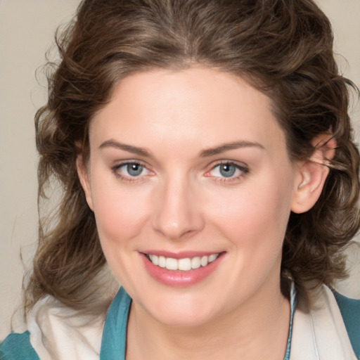 Joyful white young-adult female with medium  brown hair and blue eyes