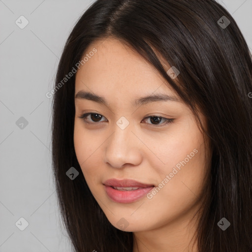 Joyful asian young-adult female with long  brown hair and brown eyes