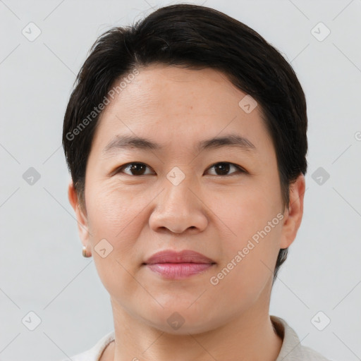 Joyful asian young-adult male with short  brown hair and brown eyes