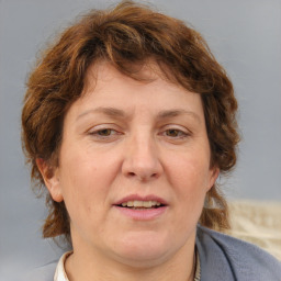 Joyful white adult female with medium  brown hair and blue eyes