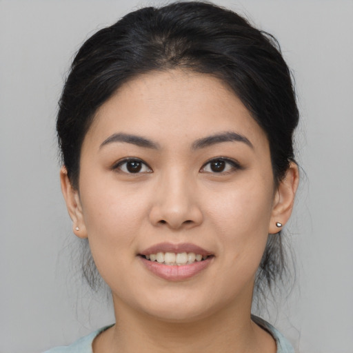 Joyful asian young-adult female with medium  black hair and brown eyes