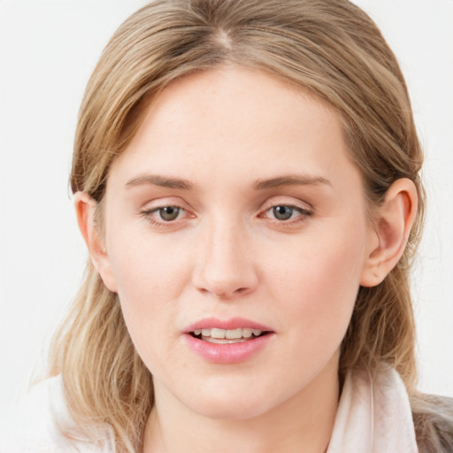 Joyful white young-adult female with medium  brown hair and blue eyes