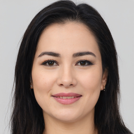Joyful white young-adult female with long  brown hair and brown eyes