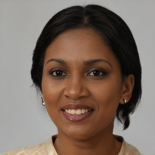 Joyful black young-adult female with medium  black hair and brown eyes