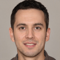 Joyful white young-adult male with short  brown hair and brown eyes