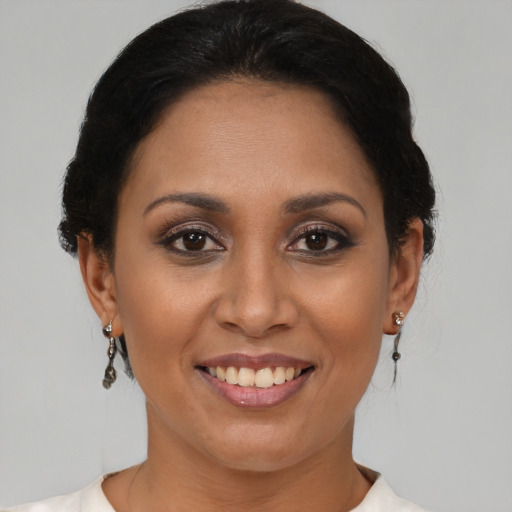 Joyful latino adult female with short  brown hair and brown eyes