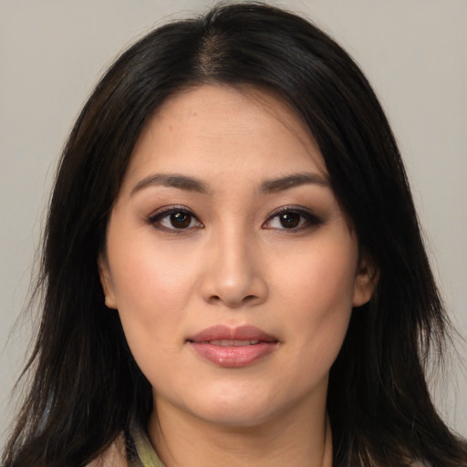Joyful asian young-adult female with long  brown hair and brown eyes