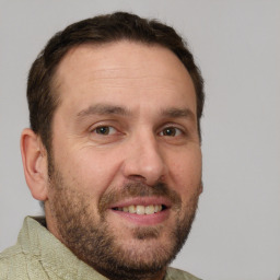 Joyful white adult male with short  brown hair and brown eyes