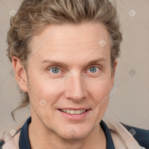 Joyful white adult male with short  brown hair and grey eyes