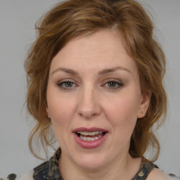 Joyful white young-adult female with medium  brown hair and blue eyes