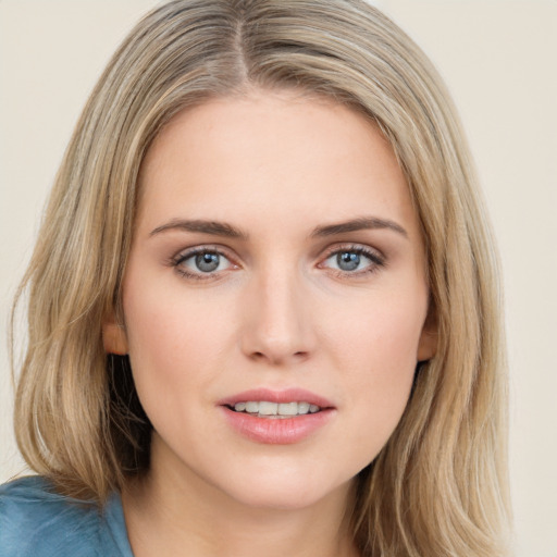 Joyful white young-adult female with medium  brown hair and blue eyes