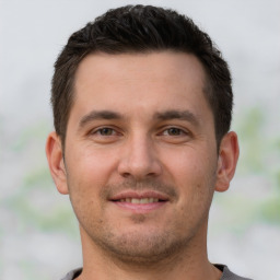 Joyful white young-adult male with short  brown hair and brown eyes