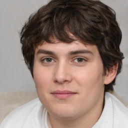 Joyful white young-adult male with medium  brown hair and brown eyes
