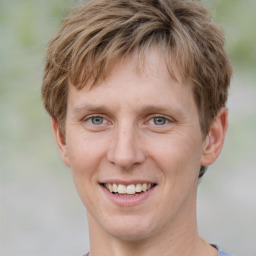 Joyful white young-adult male with short  brown hair and grey eyes