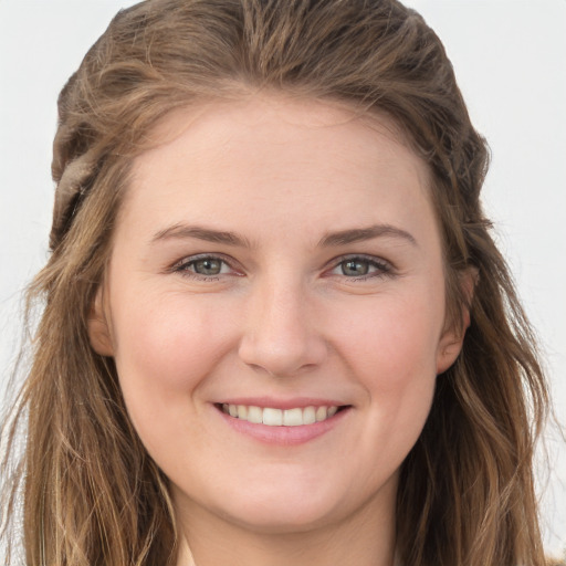 Joyful white young-adult female with long  brown hair and grey eyes