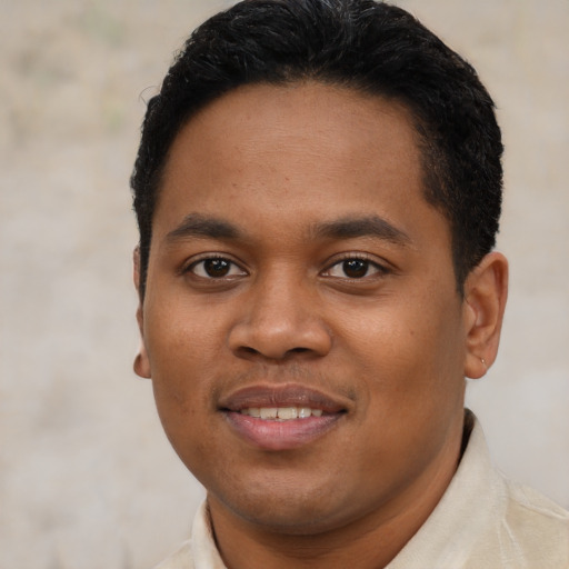 Joyful black young-adult male with short  brown hair and brown eyes