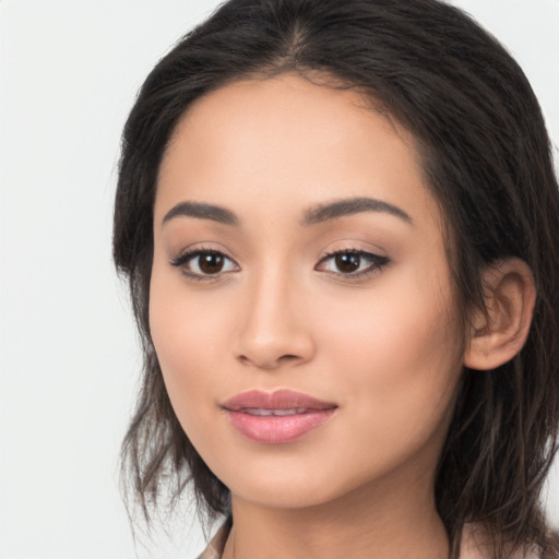 Joyful latino young-adult female with long  brown hair and brown eyes