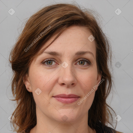 Joyful white adult female with medium  brown hair and grey eyes