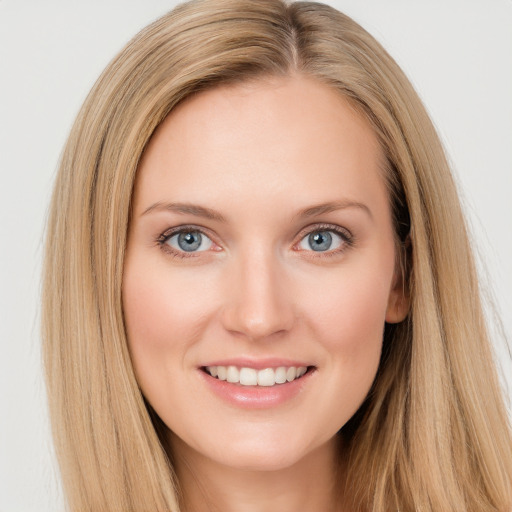 Joyful white young-adult female with long  brown hair and blue eyes