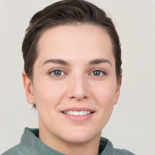 Joyful white young-adult female with short  brown hair and grey eyes