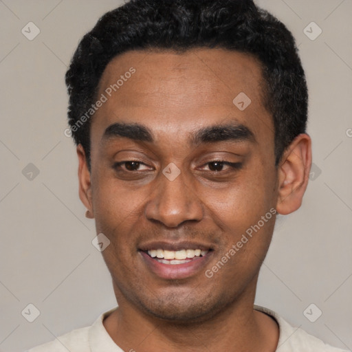 Joyful black young-adult male with short  black hair and brown eyes