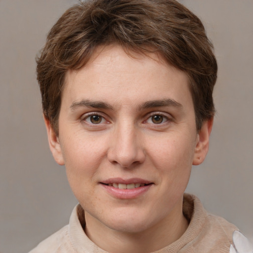 Joyful white young-adult female with short  brown hair and grey eyes