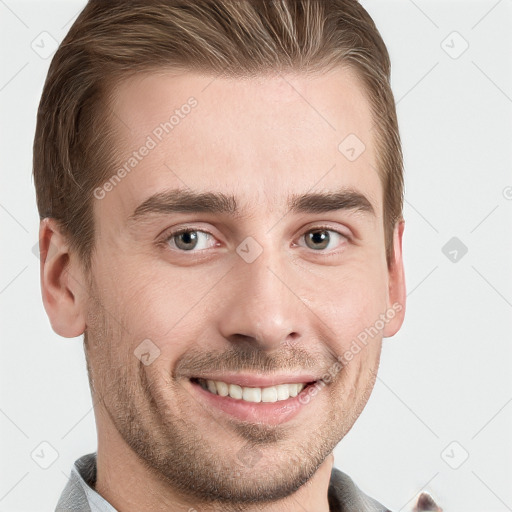 Joyful white young-adult male with short  brown hair and grey eyes