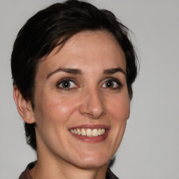 Joyful white adult female with medium  brown hair and brown eyes